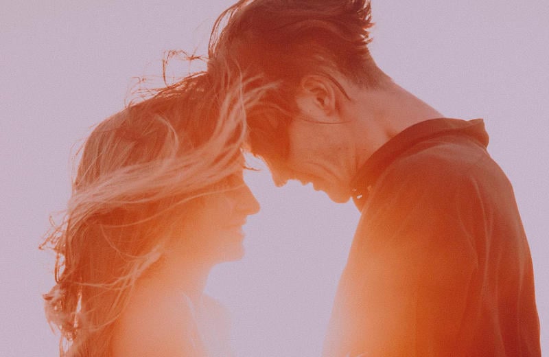 Man and woman feeling close at sunset